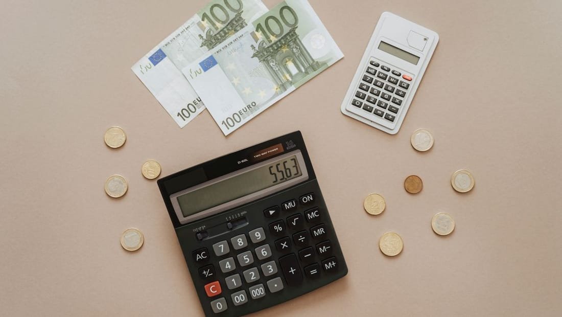 Calculator and money representing website budgeting