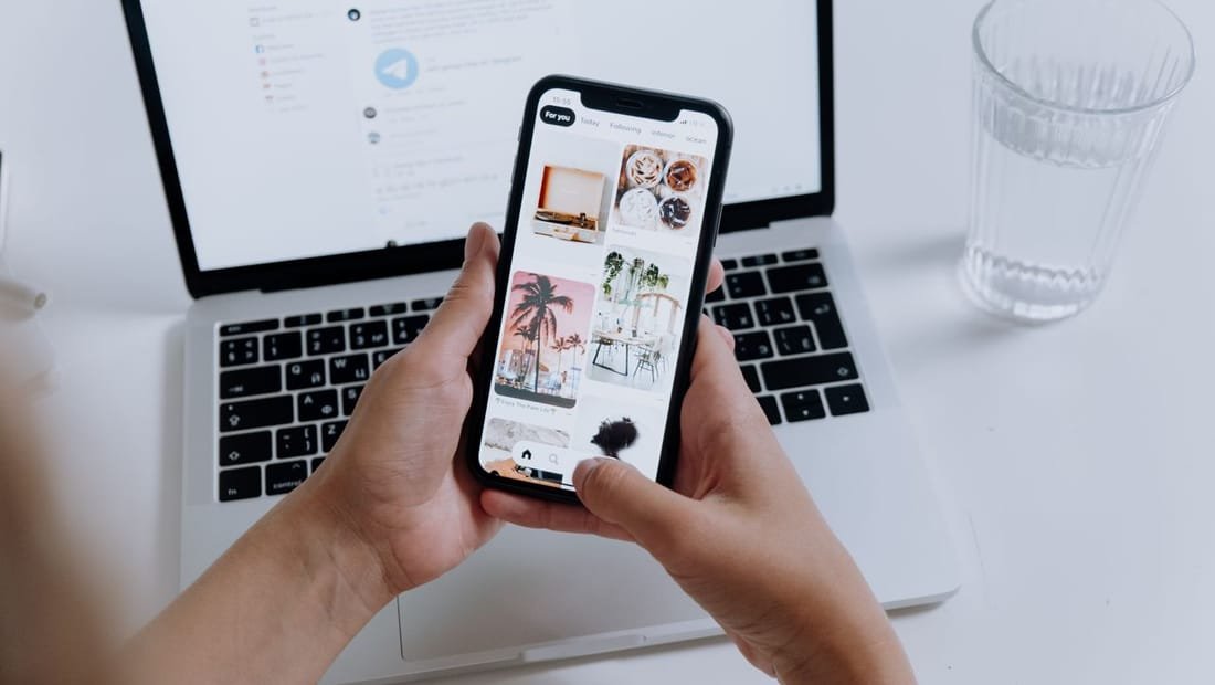 Hands holding a phone showing a property app