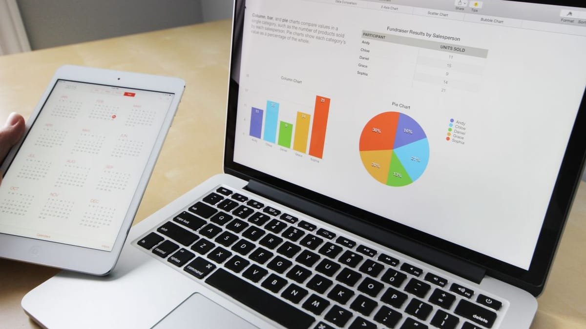 Laptop showing website analytics and charts on a desk