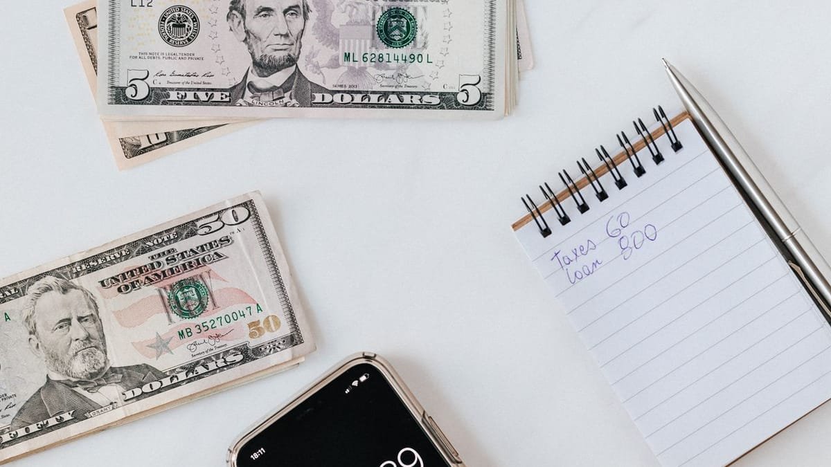 Money and a phone representing ad spend decisions