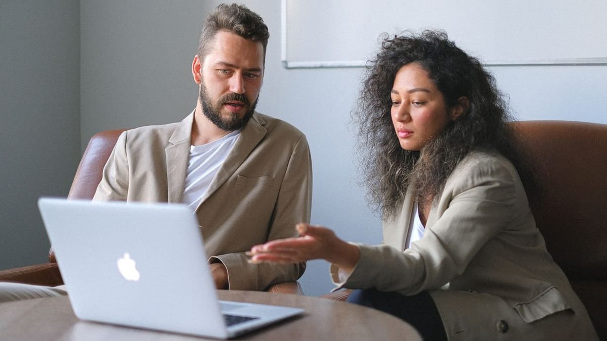 Confident real estate professional with a laptop